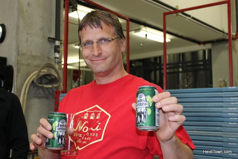 Ryan holding our fresh cans of Modus Hoperandi IPA at Ska Brewing in Durango. HeidiTown.com
