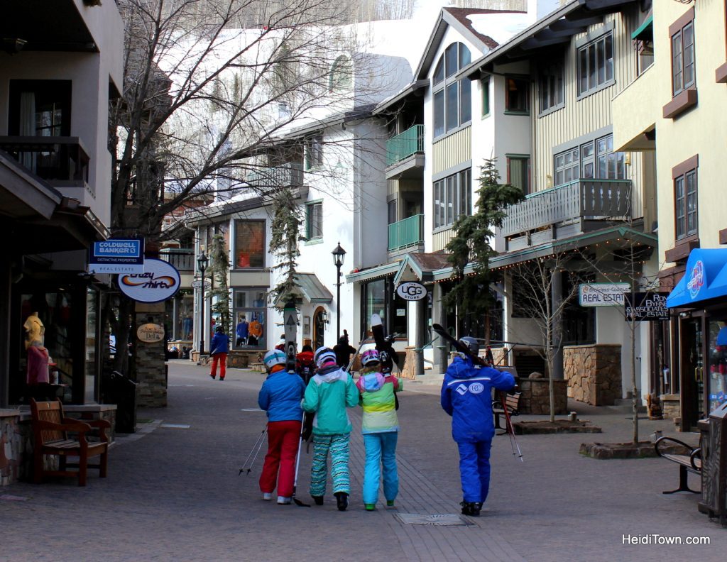 Skiers carry skis through Vail Village in Vail, Colorado. HeidiTown.com