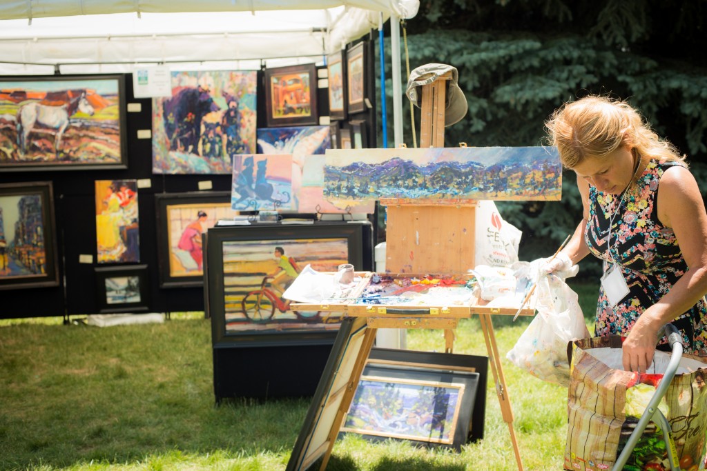 Shopper browsing art at Art on the Green in Lyons, Colorado.